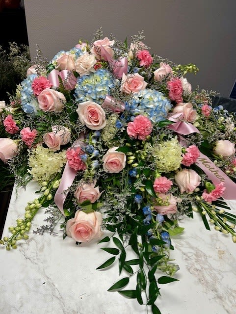 Large pastel floral spray with pink roses and blue hydrangeas