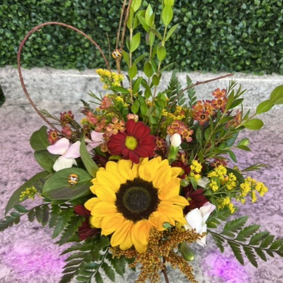 Sunflower bouquet with red and yellow mixed blooms in a hand-tied arrangement