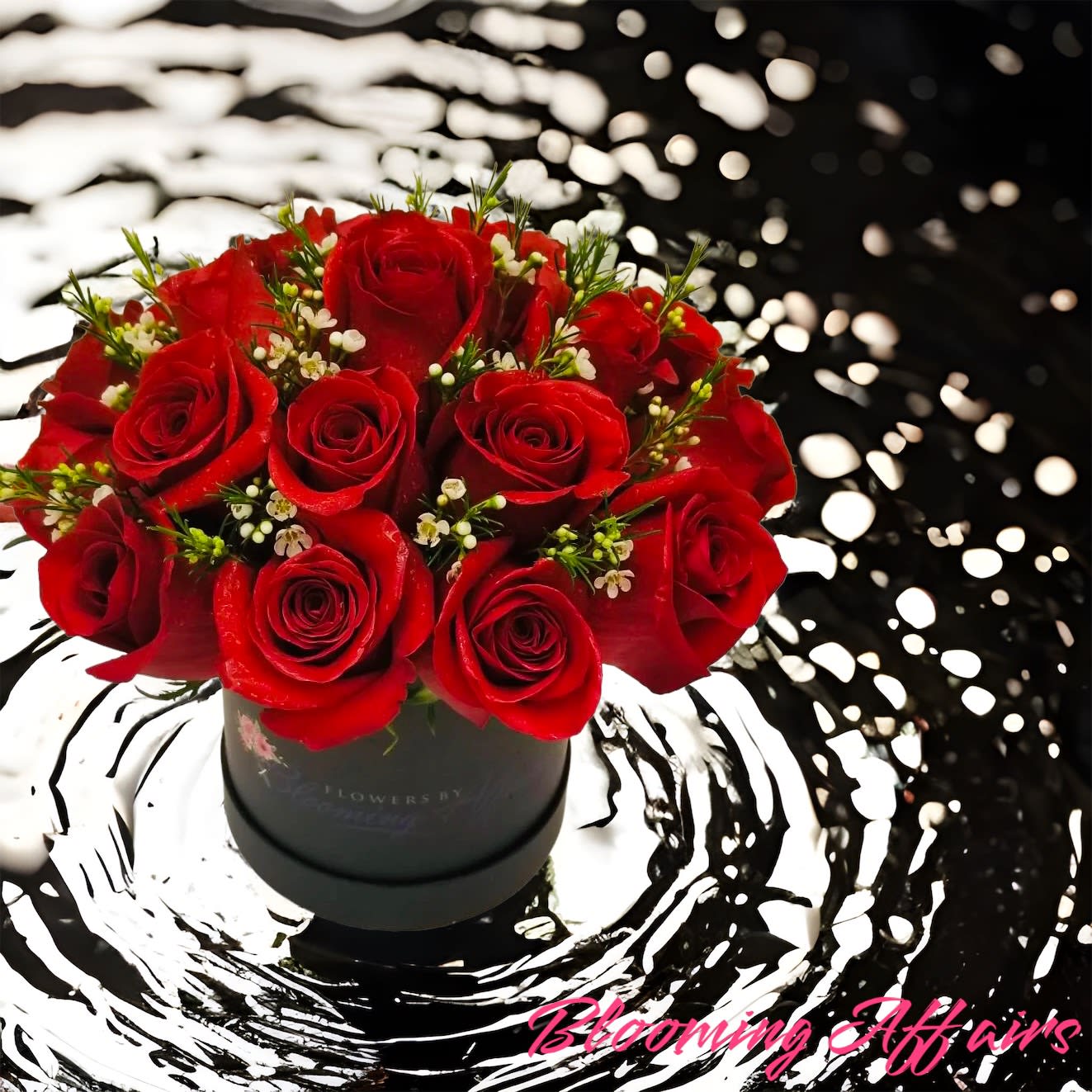 Red roses arranged in a black round box