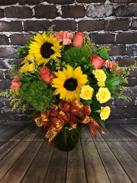 Seasons Change - A beautiful mixture of sunflowers, roses, carnations, and other flowers to fill you season with color. Approx.  15"W x 18" H