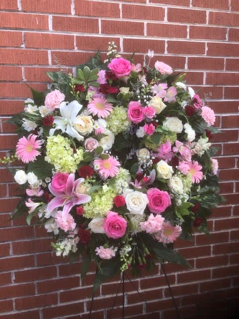Large pink and white floral standing spray with lilies and roses