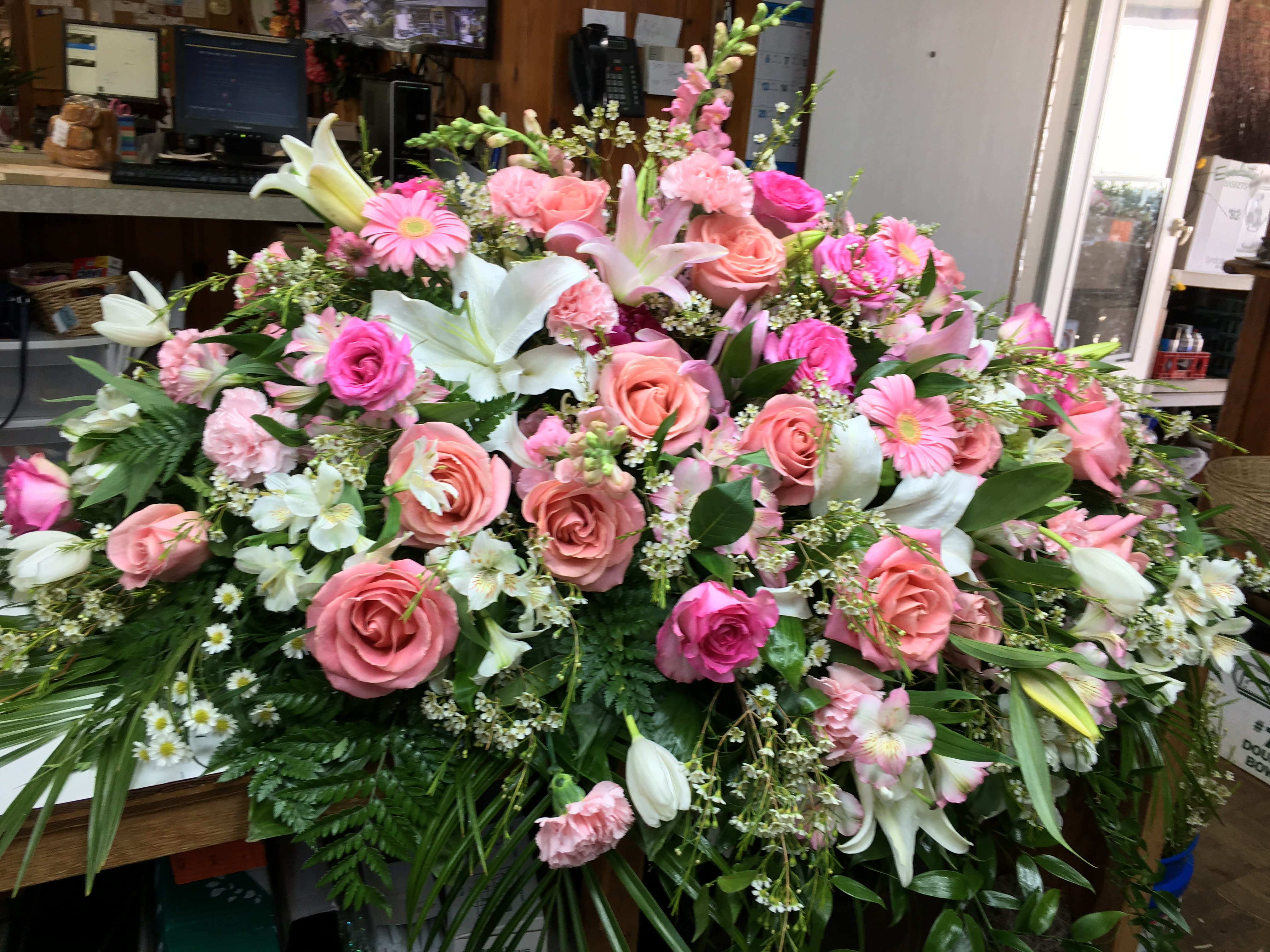 Large pink and white floral arrangement with roses and lilies