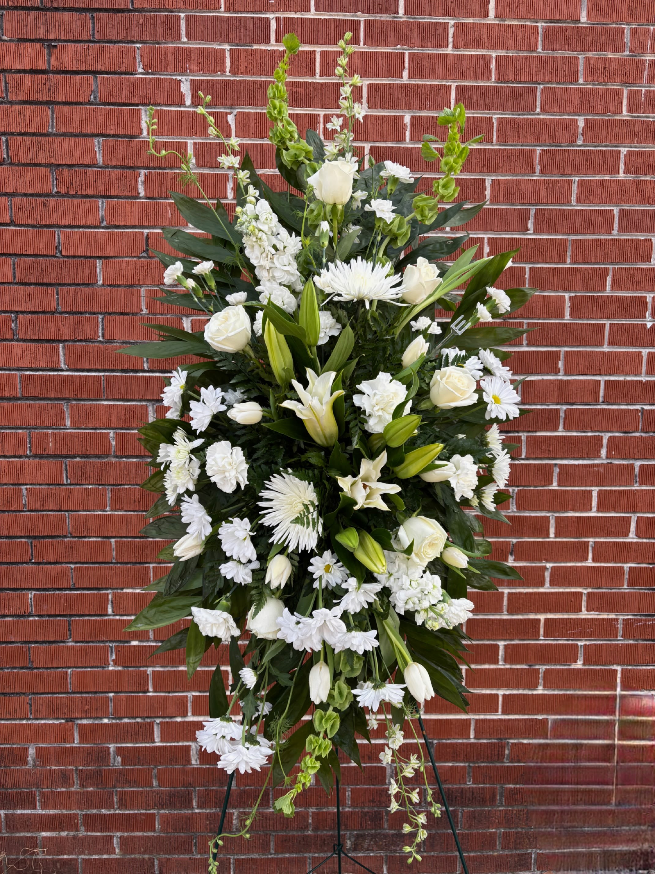 GENTLE MEMORIES - A FRESH ALL WHITE FLORAL STANDING SPRAY.