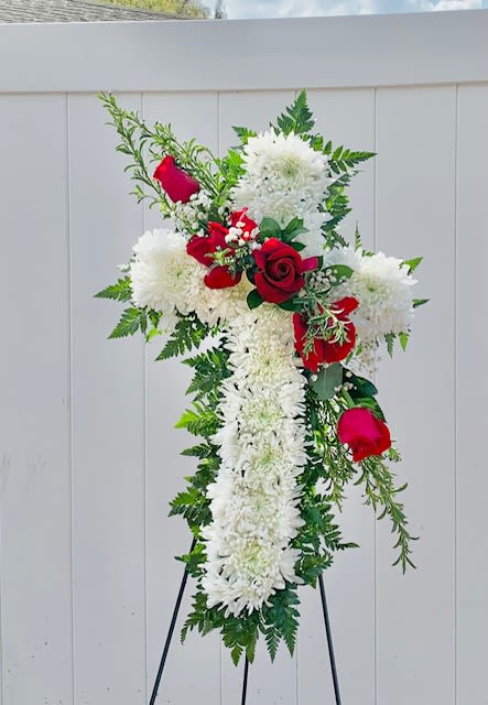 Standing floral cross with white flowers and red roses