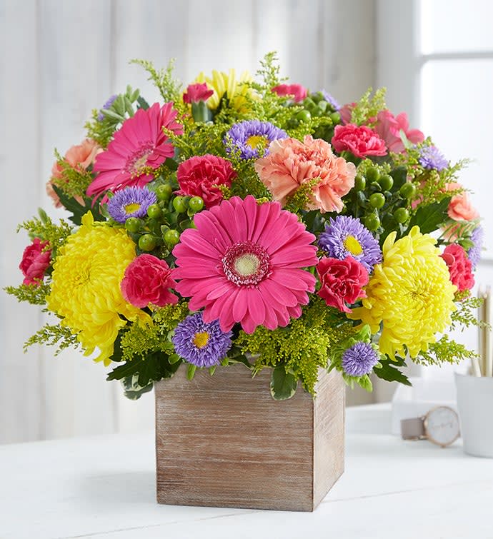 Colorful mixed flower arrangement in a wooden box