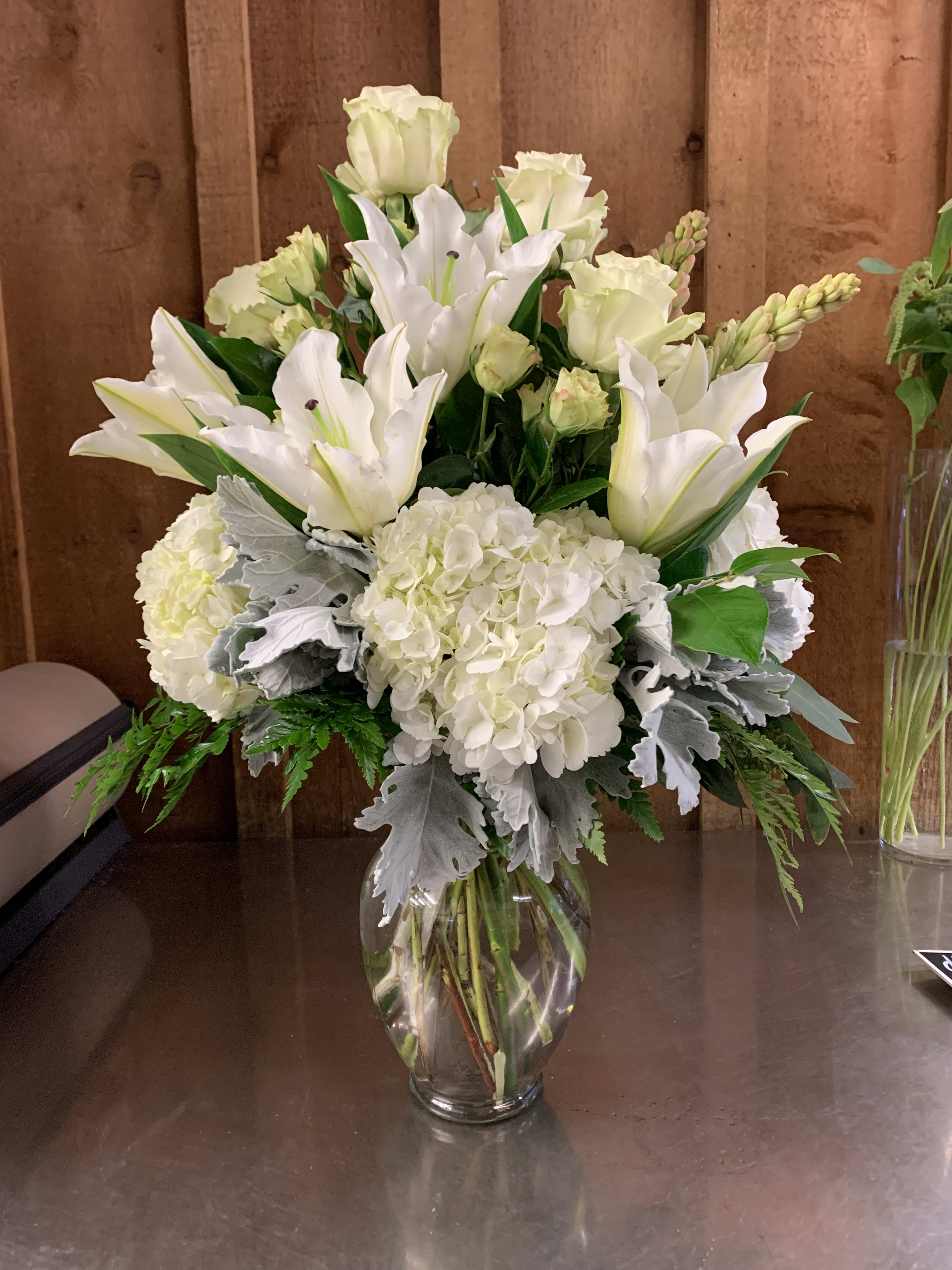 Blooming Spring  - Beautiful assortment of spring favorites. Hydrangeas, Roses , Lillies and exotic greens 