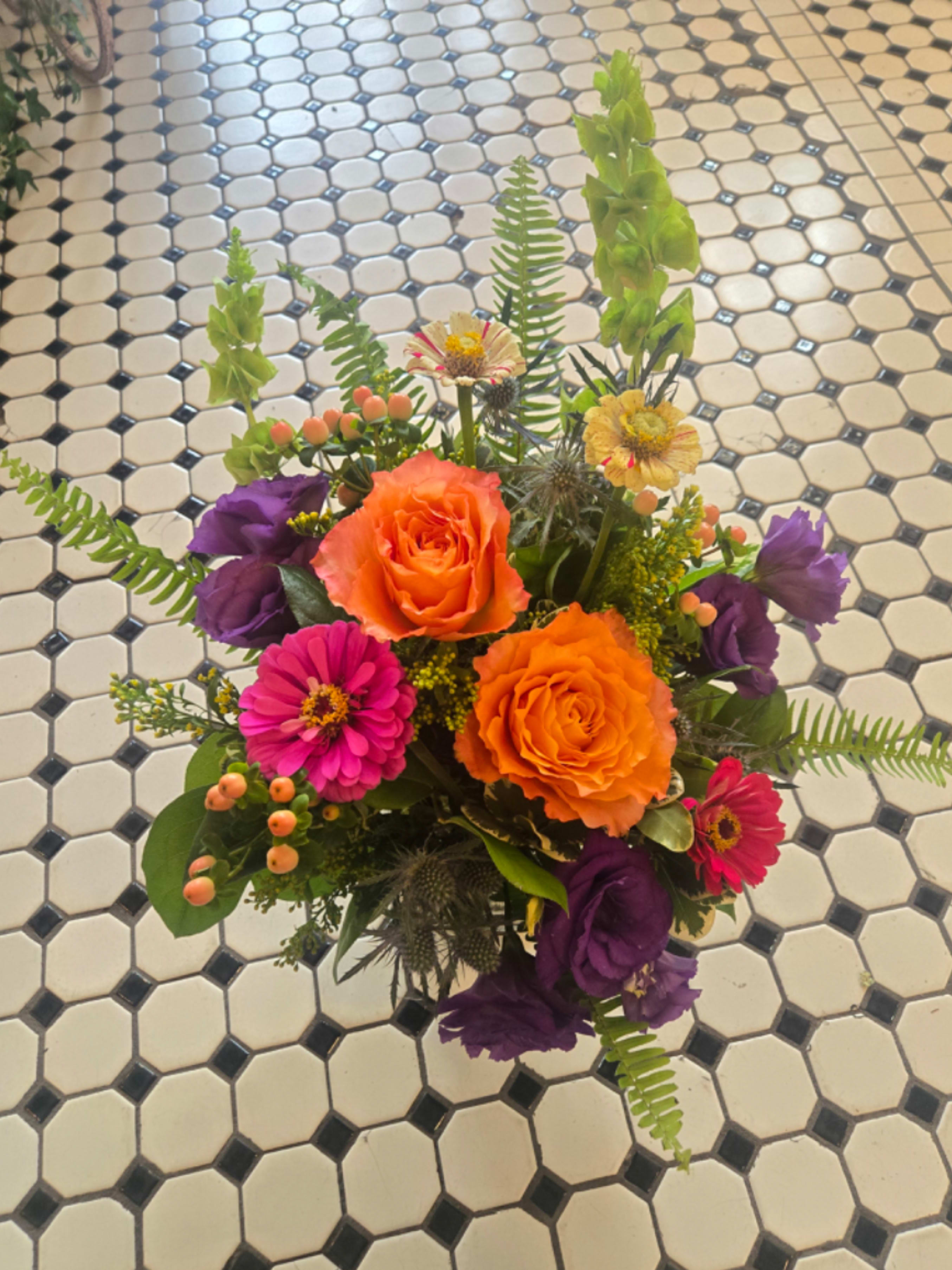 Summer Fields - Summer Fields is filled with bright and colorful flowers perfectly capturing a Missouri summer. With beautiful locally grown flowers like purple Lisianthus and multicolored zinnias, along with stunning Roses and Bells of Ireland, This arrangement is sure to brighten the spirits of anyone.