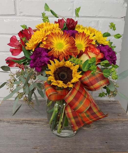 Fall Joy - Fall Joy is a mix of Fall mums, a sunflower, orange rose and carnations in a clear vase... beautiful!
