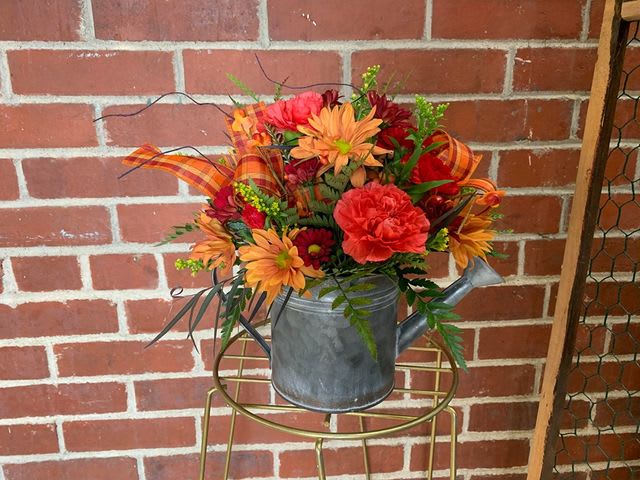 Fall flower arrangement in a metal watering can