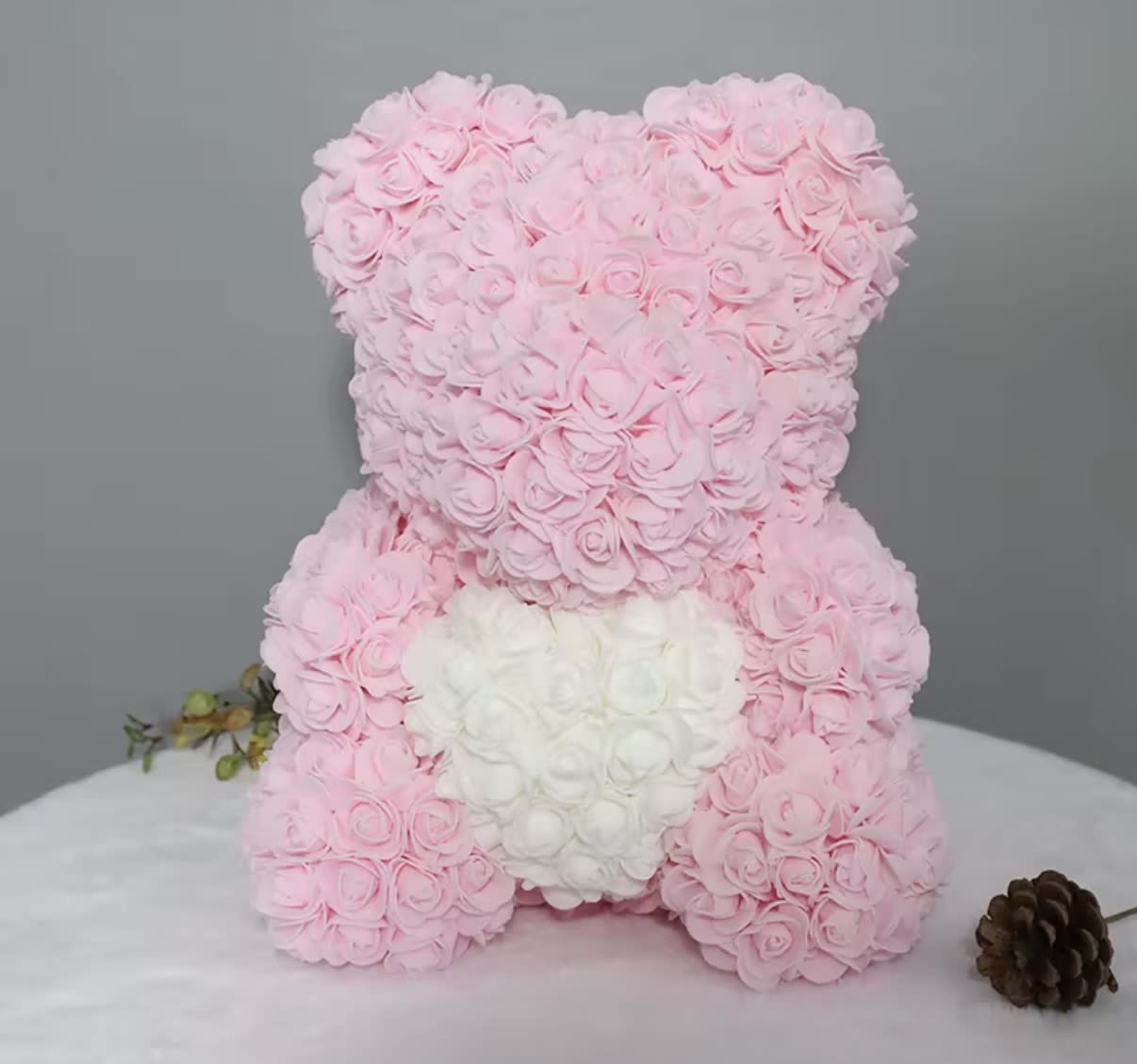 Pink and white rose teddy bear on a table