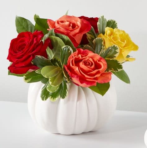 Mixed roses in a white pumpkin-shaped vase
