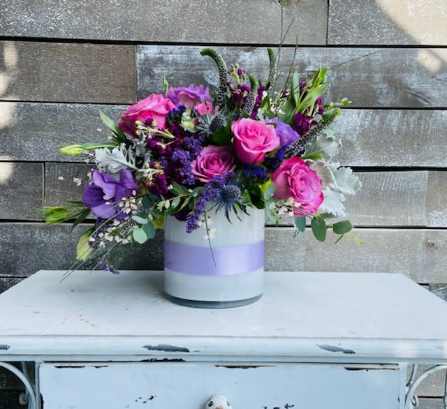 Bouquet of pink and purple flowers in a white vase