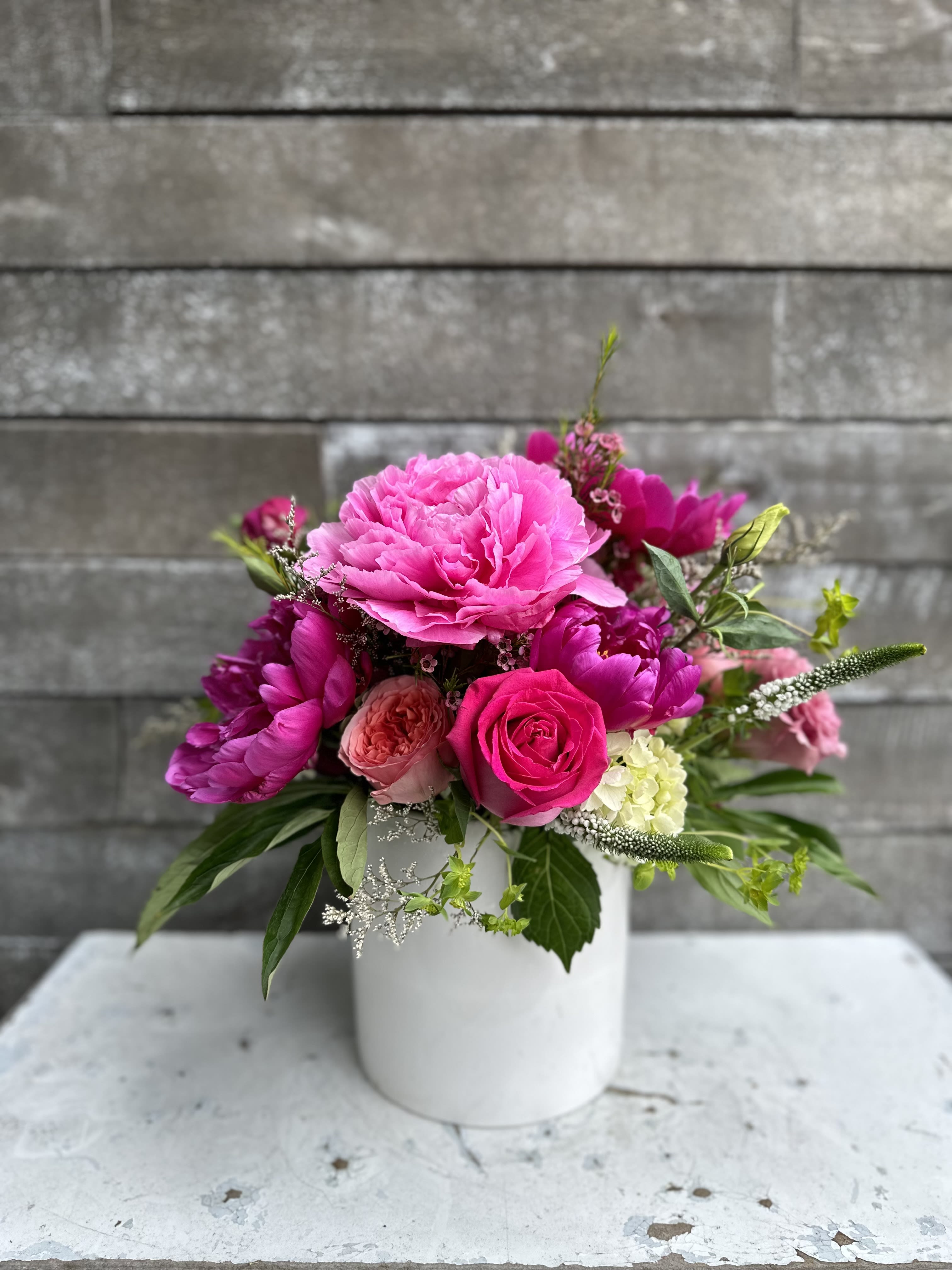 Pink floral arrangement in a white vase