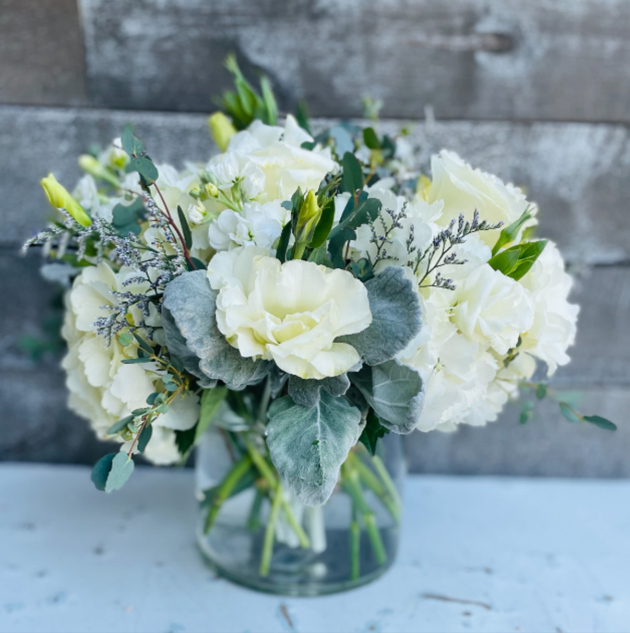 White floral bouquet in a clear glass vase
