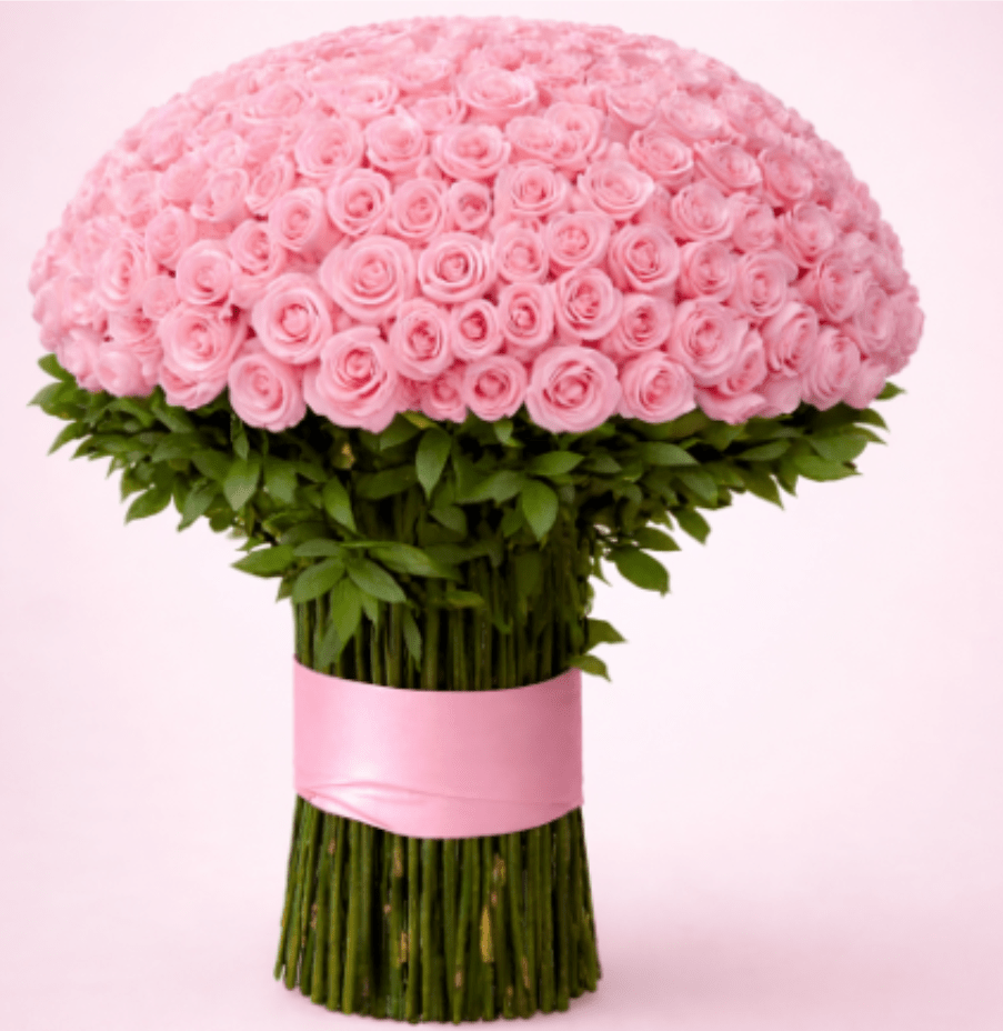 Pink Perfection - A delicate yet luxurious floral design that radiates elegance, tenderness, and refined romance. This stunning arrangement features premium light pink roses, artistically arranged into heart shapes, symbolizing admiration, grace, and everlasting affection.  The design is beautifully elevated with white and soft pink orchids, adding depth, sophistication, and a timeless floral presence. Lush greenery and cascading accents complete the look, creating a harmonious and visually striking composition from every angle.  Perfect for anniversaries, engagements, birthdays, baby showers, Mother’s Day, or any moment that deserves to feel truly special.