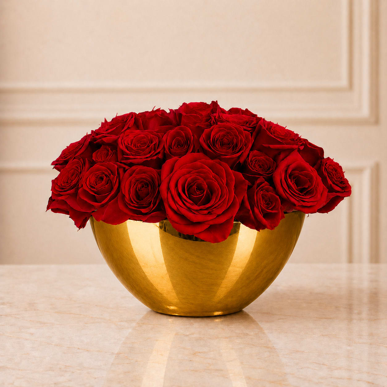 Red roses arranged in a gold bowl vase