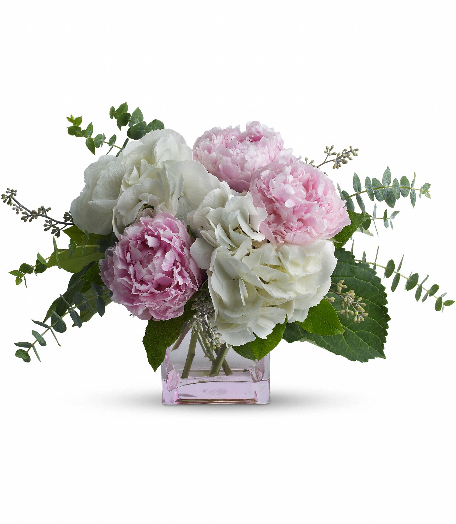 Pretty in Peony - The charming bouquet includes pink peonies and white hydrangea accented with seeded and spiral eucalyptus. The flowers are delivered in a contemporary pink cube vase. Bouquet is approximately 17 1/2â W x 12â H