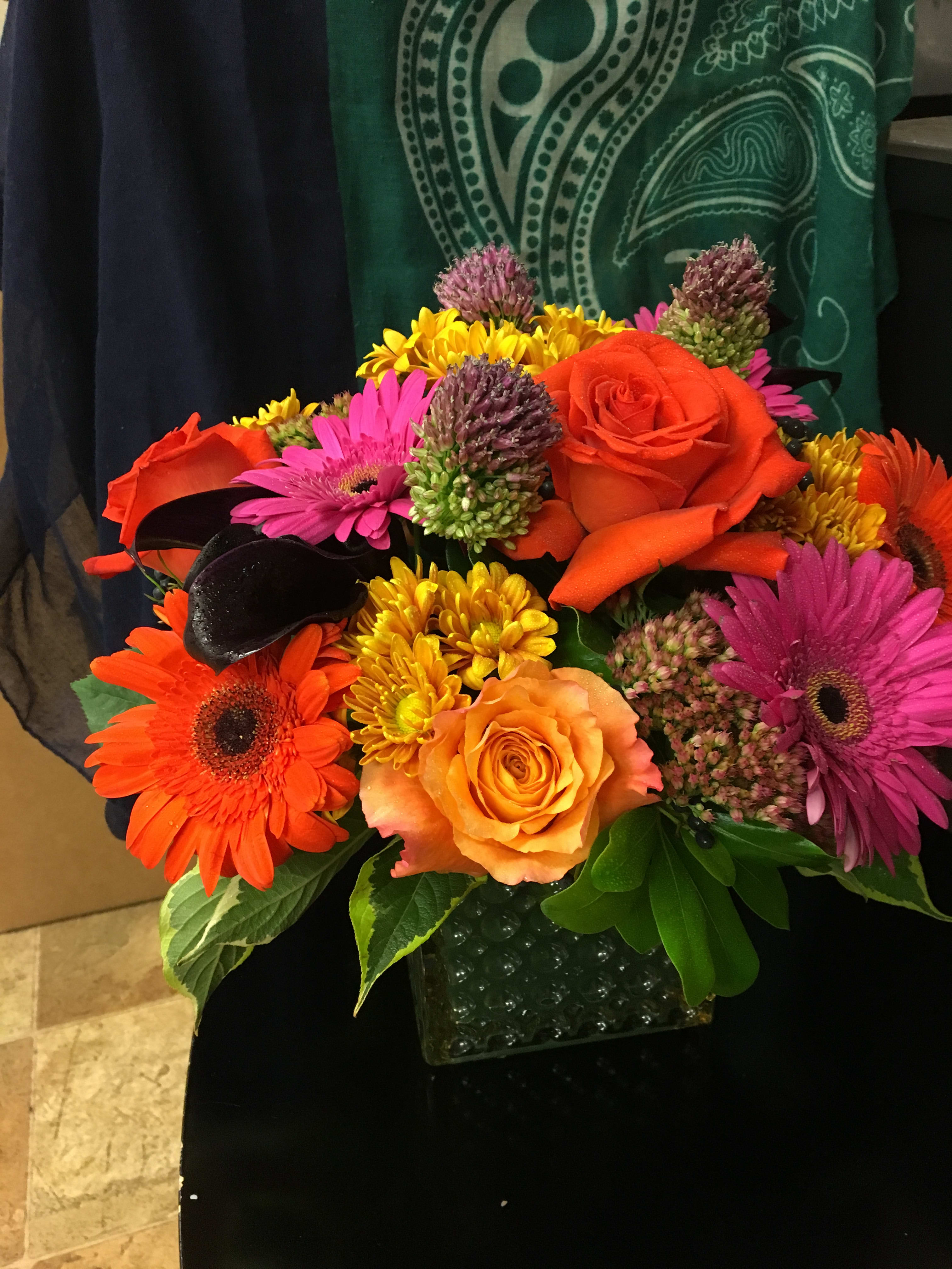 Jewel Rainbow: roses, gerberas, and more - A vivid collection of  bold hues with lasting beauty, presenting roses and gerberas among other beautiful flowers. Upgrade provide larger sizes.