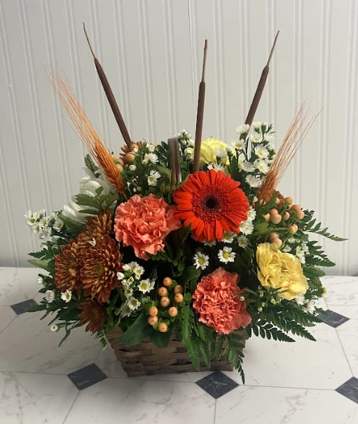 Cinnamon Sugar - Sweet, warm, and perfectly seasonal, this arrangement comes in a charming brown basket filled with rich fall blooms. Shades of orange, gold, and bronze mingle together like autumn spices, creating a comforting display that evokes the cozy feeling of cinnamon and sugar treats. Ideal as a centerpiece, gift, or seasonal accent, it brings a touch of autumn warmth to any space.