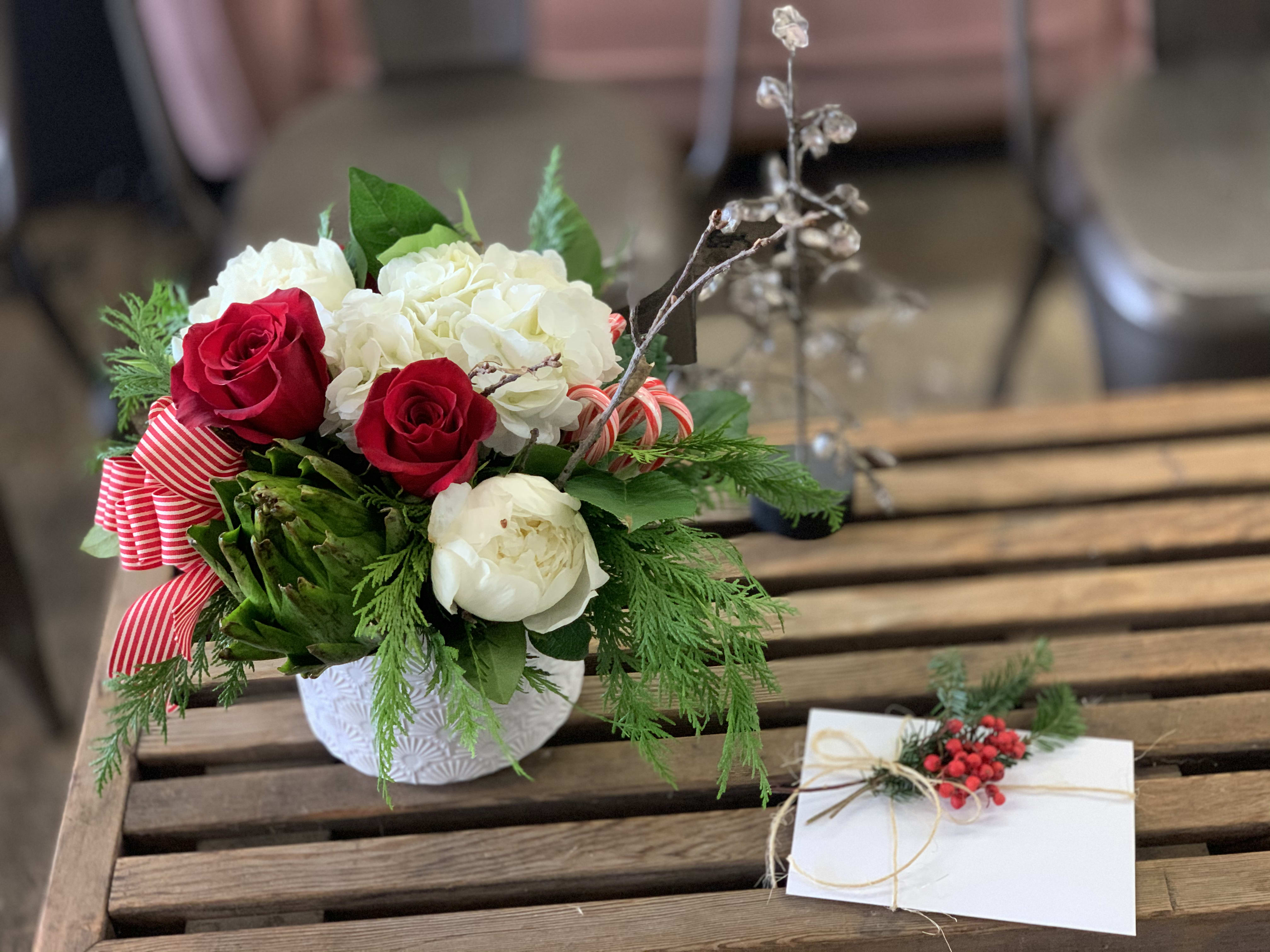 Candy Cane Wonderland - Exquisite design made up of red tipped Sweetness roses, cedar, pine, coffee bean, and garnished with real candy canes! Perfect for this holly jolly season! 