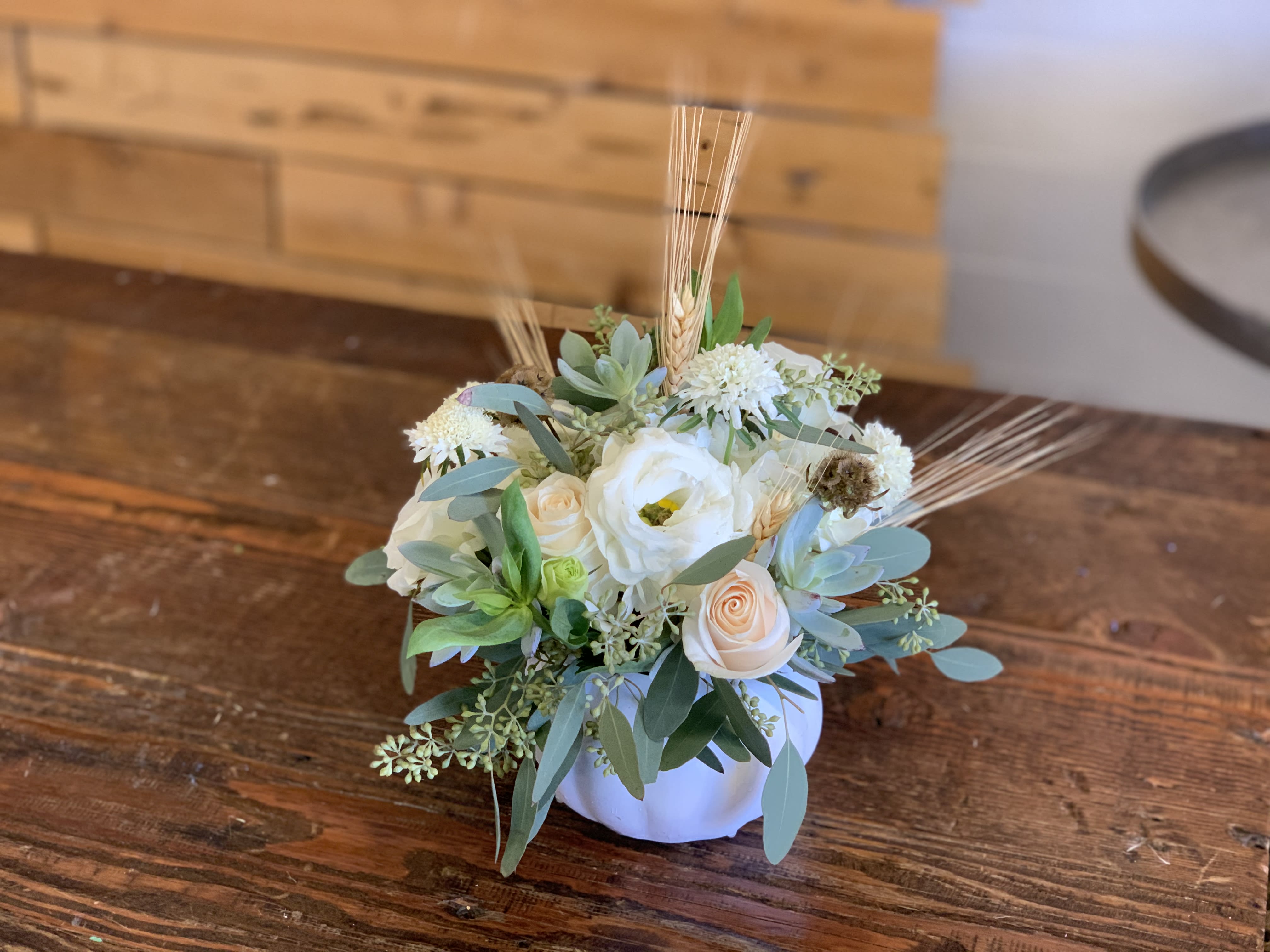 Ivory Pumpkin Blooms - Stunning mix of ivory and white blooms, eloquently designed in a ceramic pumpkin vase. Perfect for your dinner table's  centerpiece!!  pictured [DELUXE]