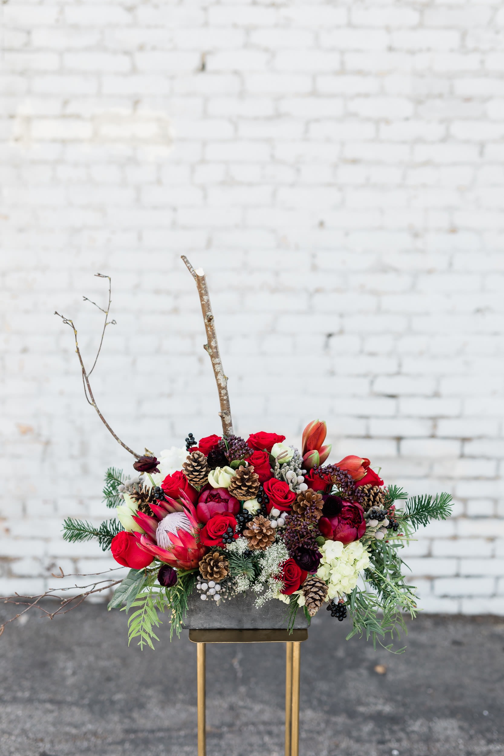 Noel's Blooms - Stunning mix of holiday greens and blooms, all designed in a ceramic designer vase. Perfect for the holiday seasons!  pictured [PREMIUM]