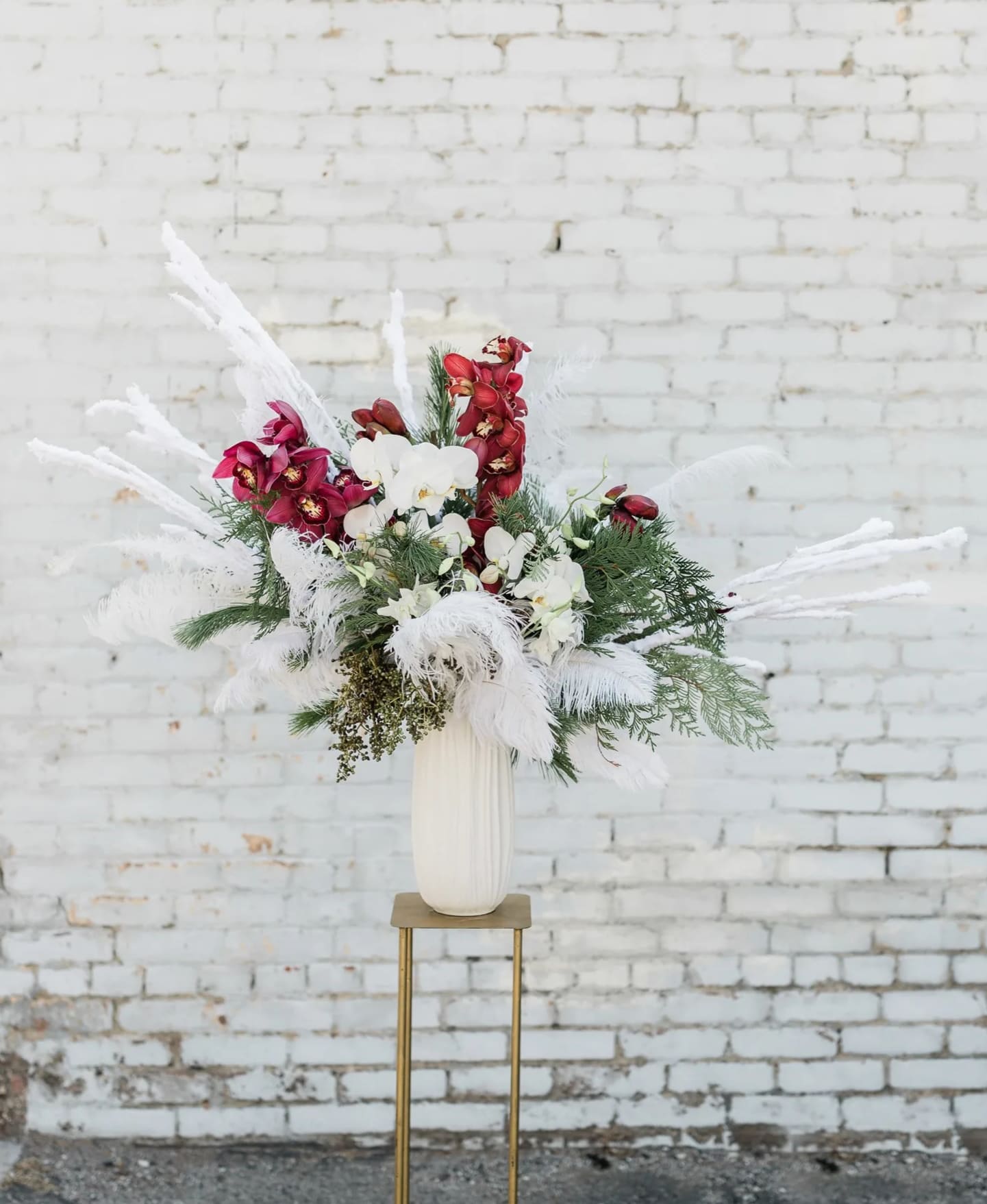 Love is a Game - Part of this year's winter collection inspired by Adele's new album, 30, this striking arrangement dives deep into tropical flair with various orchid types in festive holiday colors, all designed in one of our hand-picked designer vases.  Pictured is [PREMIUM]