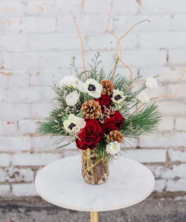 Candy Cane Lane - Cozy on up and Drink in the Holiday Spirit with our new Winter Collection! Designed to capture the essence of the holidays and bring joy to all. Take a trip down Candy Cane Lane by gifting this to your loved ones. Arranged with a stunning mix of red &amp; white premium blooms, accompanied by winter greens and textures all whimsically designed in a mason jar.  Pictured is [DELUXE]  *Some items in this arrangement must be special ordered, please allow 1-2 weeks notice to allow time for arrival of special items, otherwise, substitutions will occur.*