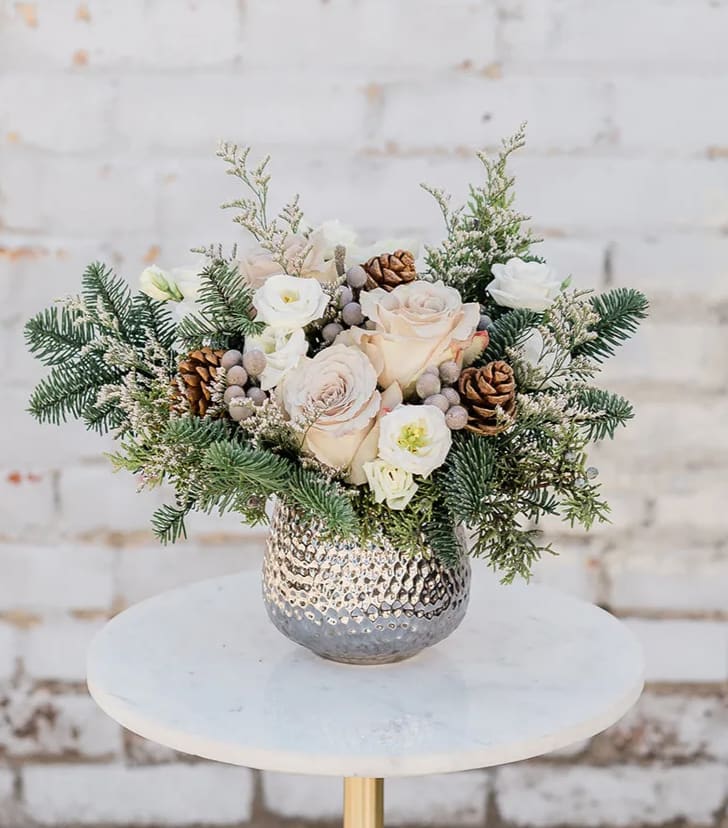 Winter Wonderland - Cozy on up and Drink in the Holiday Spirit with our new Winter Collection! Designed to capture the essence of the holidays and bring joy to all. Take a walk in a Winter Wonderland with this arrangement. Arranged with a stunning mix of neutral premium blooms, accompanied by winter greens and textures all elegantly designed in one of our hand-picked designer vases.  Pictured is [DELUXE]  *Some items in this arrangement must be special ordered, please allow 1-2 weeks notice to allow time for arrival of special items, otherwise, substitutions will occur.*