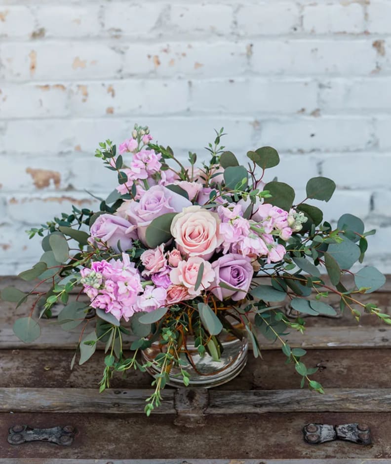 Pink and lavender rose bouquet in a clear glass vase