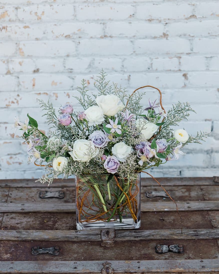Pastel flower arrangement in a square glass vase