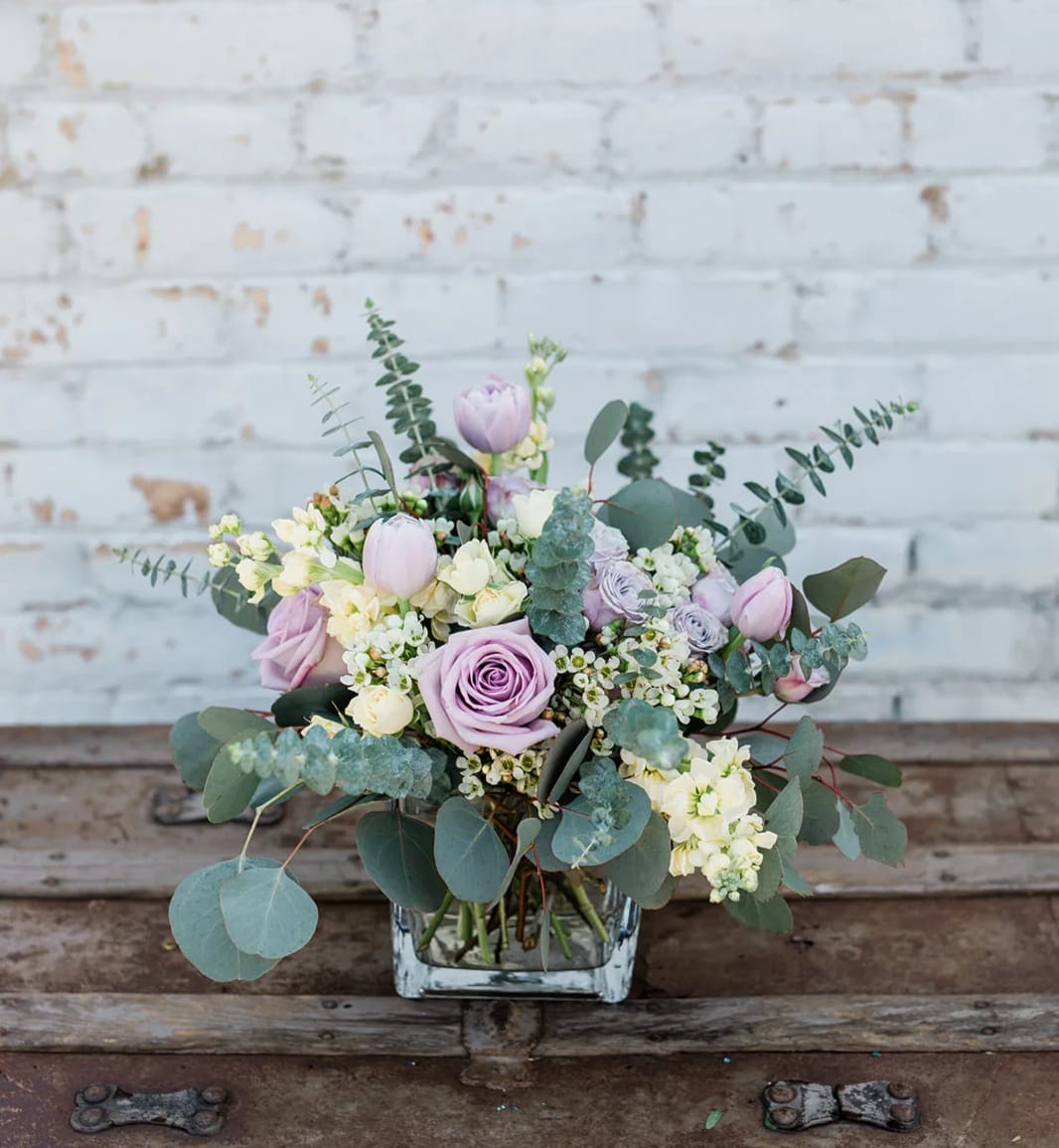 Lavender roses and tulips in a square glass vase