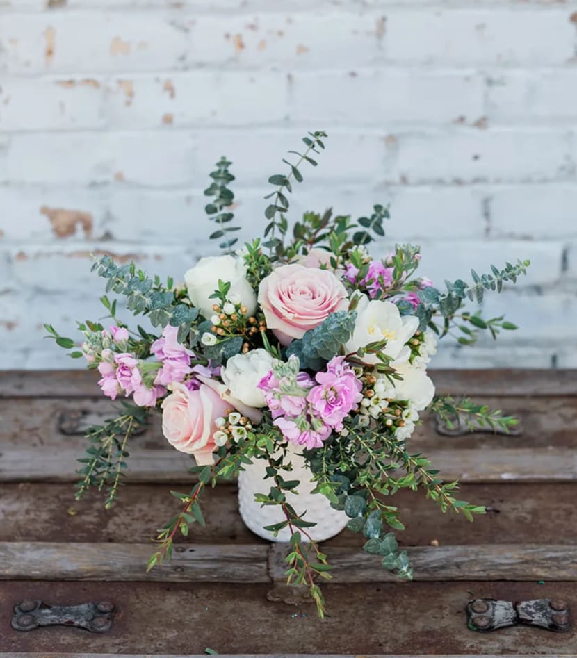 Pink and white floral arrangement in a white vase