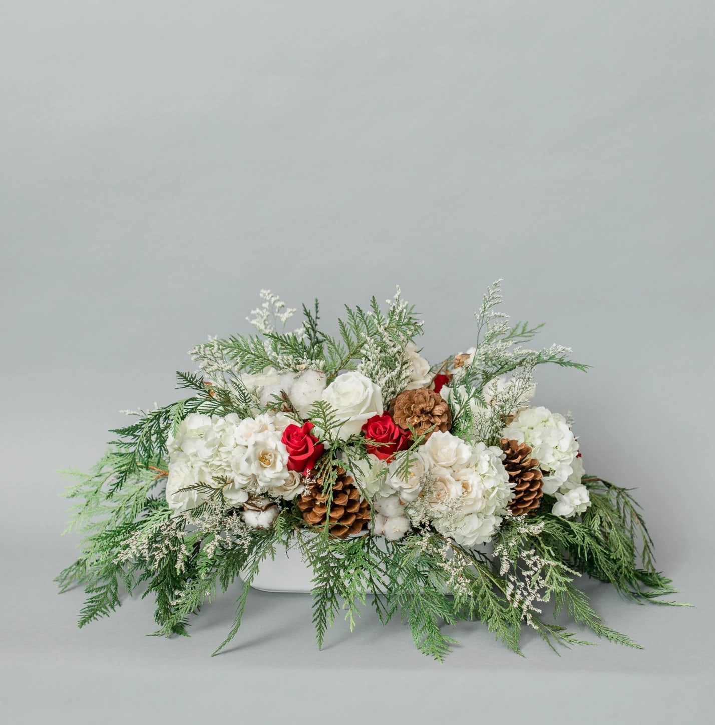 Candy Cane Fantasy - Get in the Holly Jolly Spirit with our dreamy Holiday Collection! Inspired by the warmth and memories of holidays past, Candy Cane Fantasy comes arranged with white and red premium blooms and textures, accented with holiday greens, all elegantly arranged in one of our hand-picked designer vases. Designed all the way around and can be used as a centerpiece  Pictured [STANDARD]  *Some items in this arrangement must be special ordered, please allow 1-2 weeks notice to allow time for arrival of special items, otherwise, substitutions will occur.*