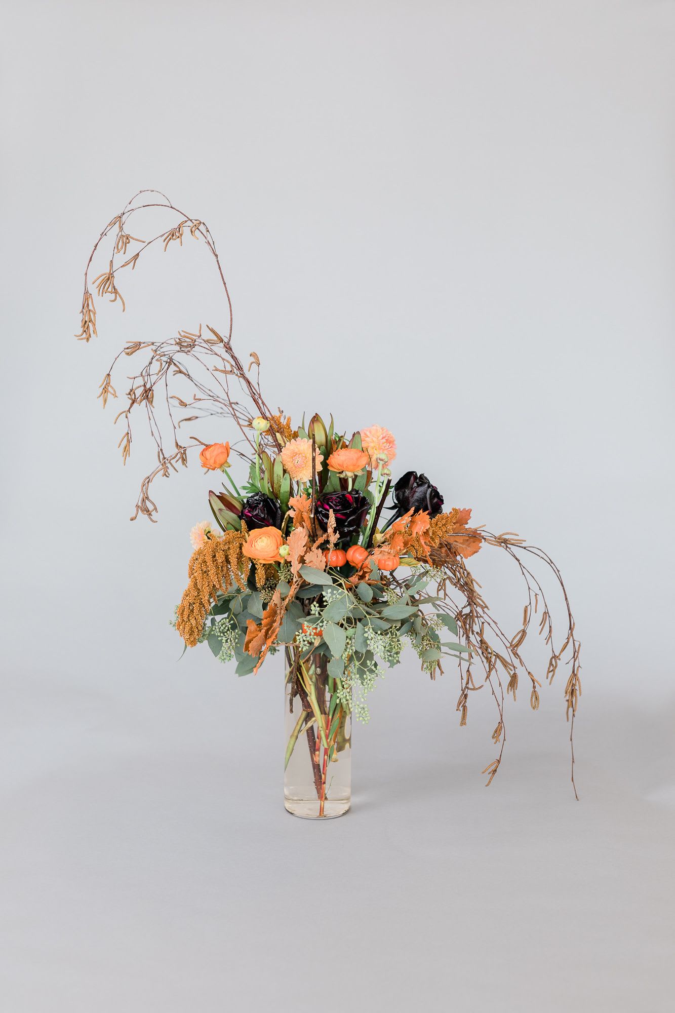 Bugs And Hisses! - This stunning holiday arrangement is made up of holiday black roses, whites, burgundies, and other macabre textures!   pictured: [DELUXE]