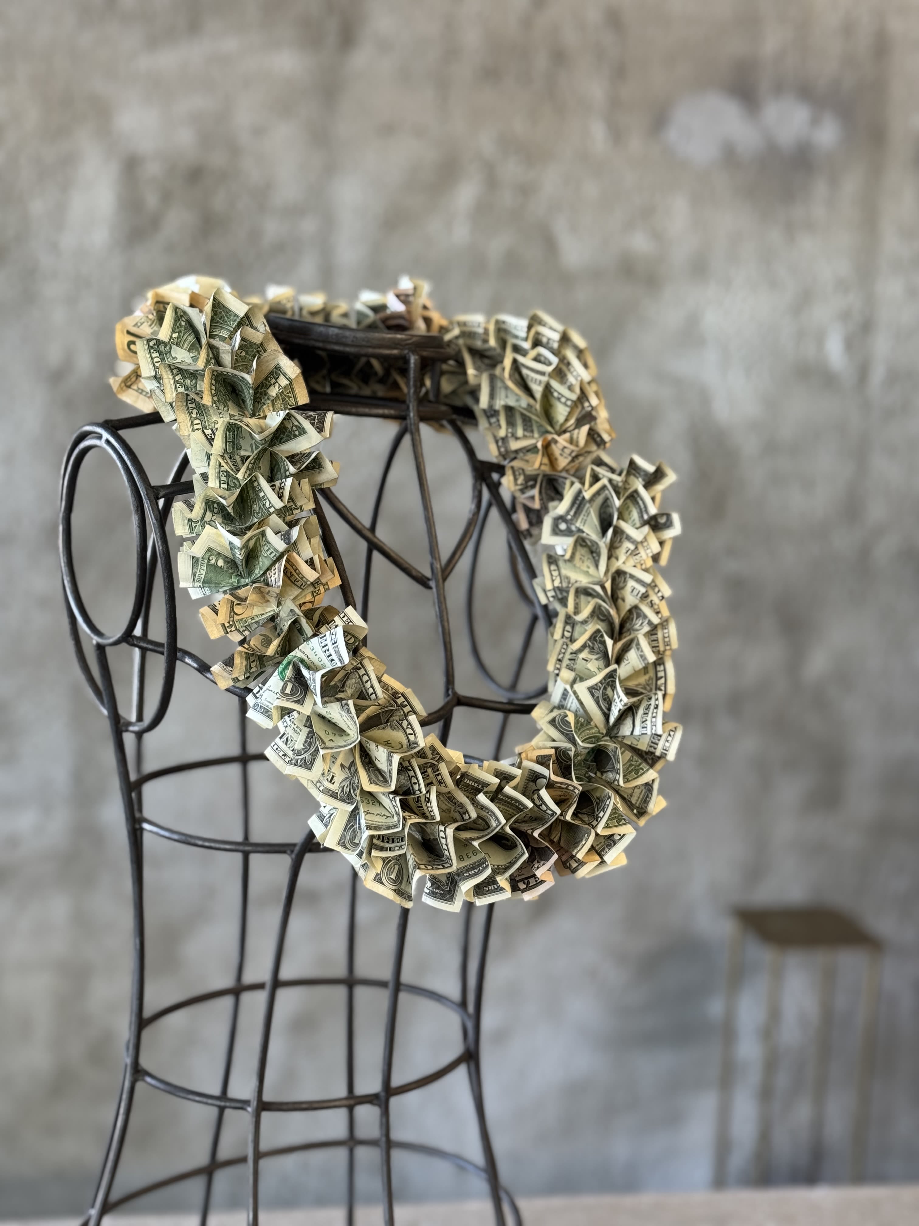 Money lei draped over a metal dress form