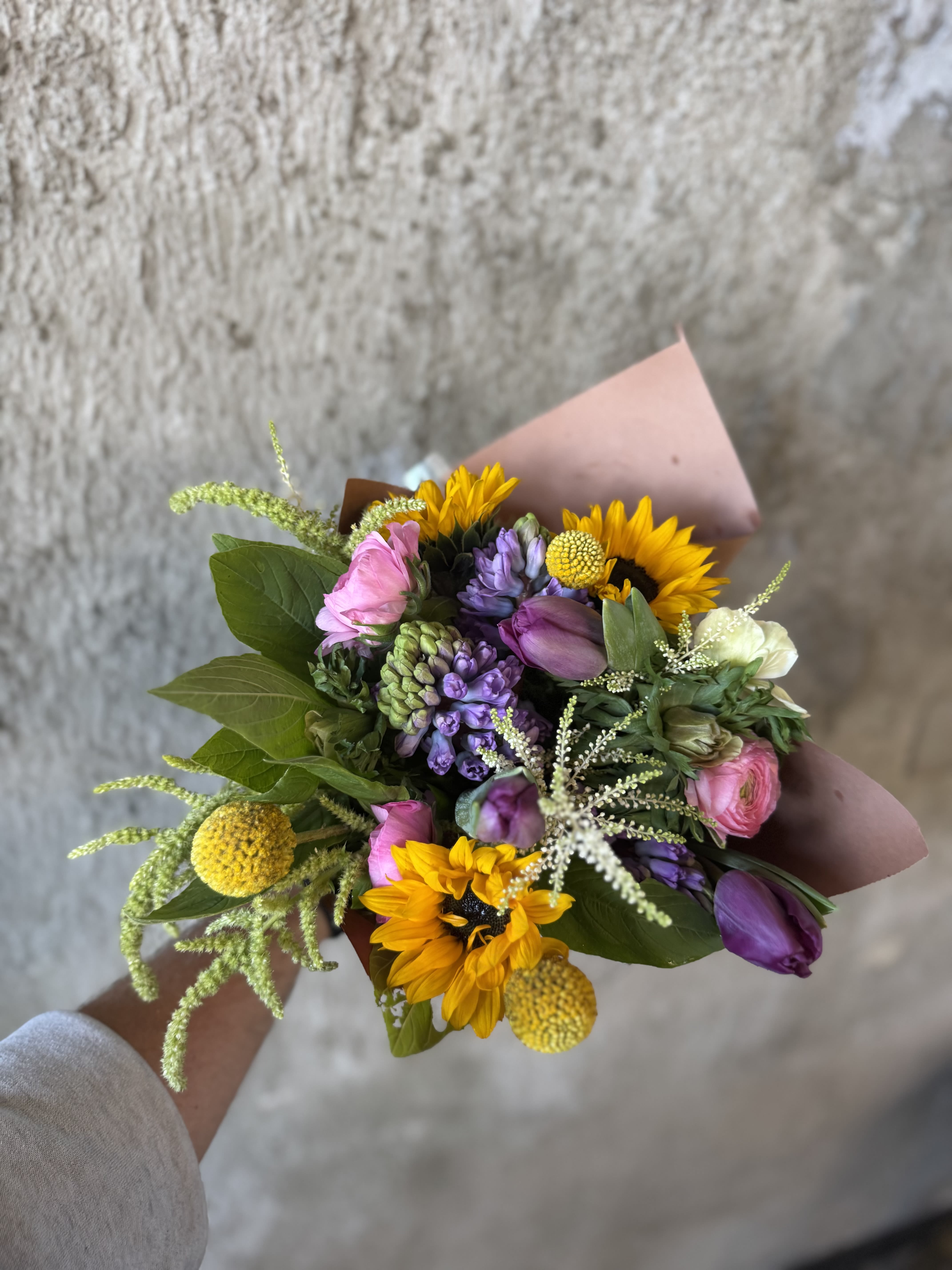 Hand-tied bouquet with sunflowers, purple and pink blooms