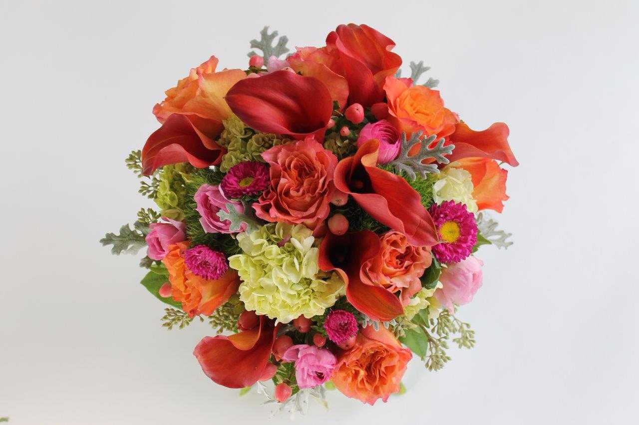 Bouquet of red calla lilies and mixed pink-orange flowers