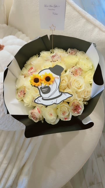 Spooky White Rose Bouquet with a Halloween Twist - "This exclusive bouquet blends the elegance of white roses with the mysterious charm of Halloween. Featuring a unique design, the bouquet is adorned with cheerful sunflowers and a playful touch of spooky flair. Perfect for those looking for a floral gift with character and style, this arrangement is ideal for celebrations, surprises, or adding a dash of magic to your home or event. Bring a little dark enchantment to your special occasion with this hauntingly beautiful bouquet!" 3 Dozen or 4 dozen