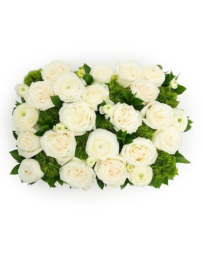 Rectangular arrangement of white ranunculus with green tufted blooms in a compact design