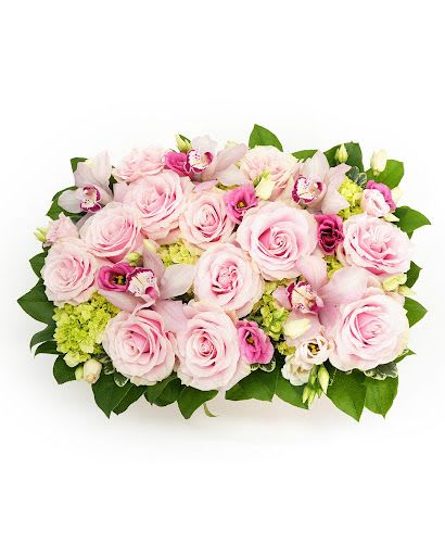 Low rectangular arrangement of pale pink roses, green hydrangeas, and pink blooms in a compact design
