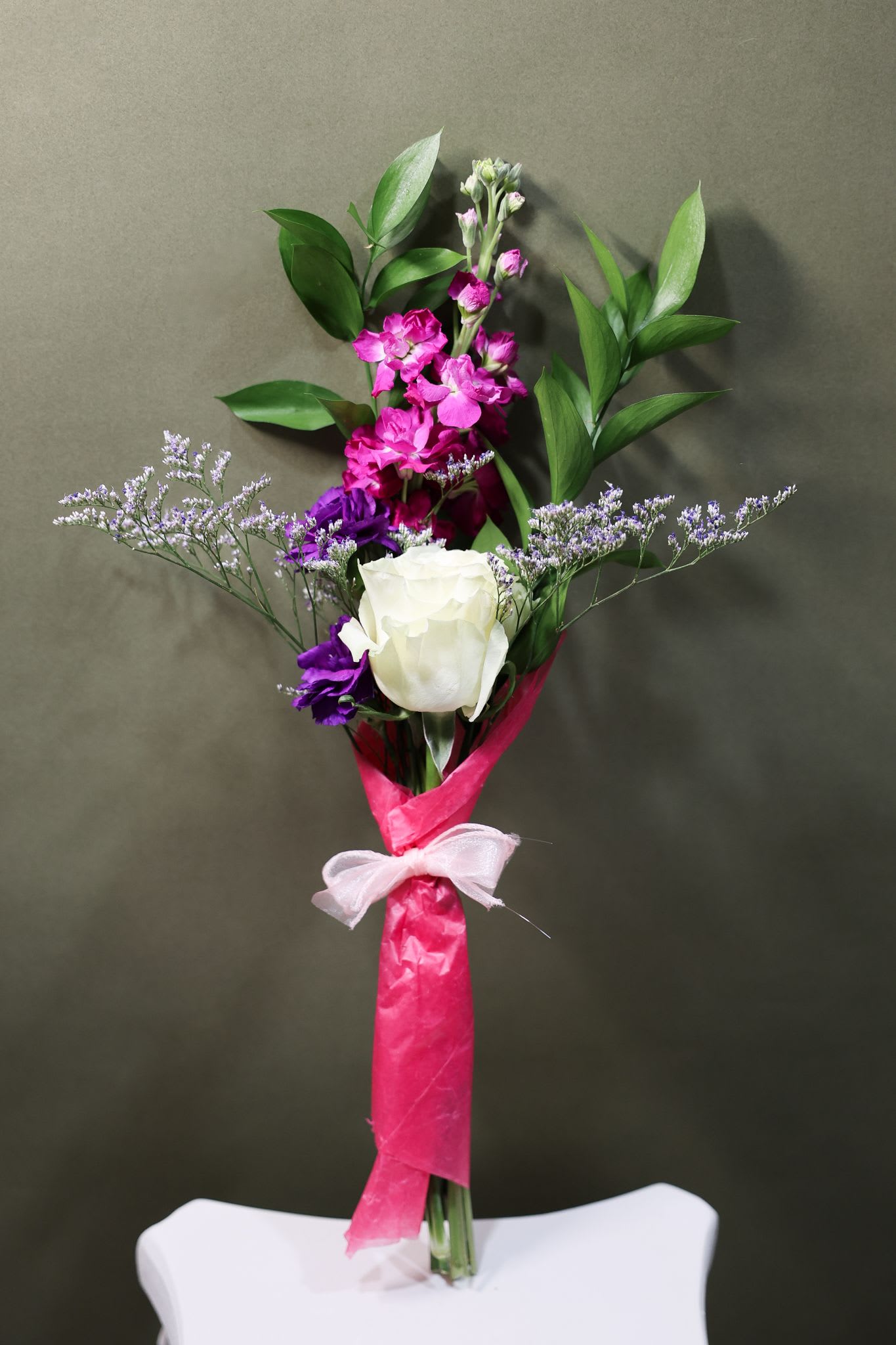 Celebration Bouquet  - Celebrate their moment on stage with Final Bow Blooms. This hand-tied bundle features a fresh rose paired with delicate accent flowers and greenery, wrapped and ready for the proud hug after the performance. The perfect little bouquet for recitals, dance shows, and standing ovations.