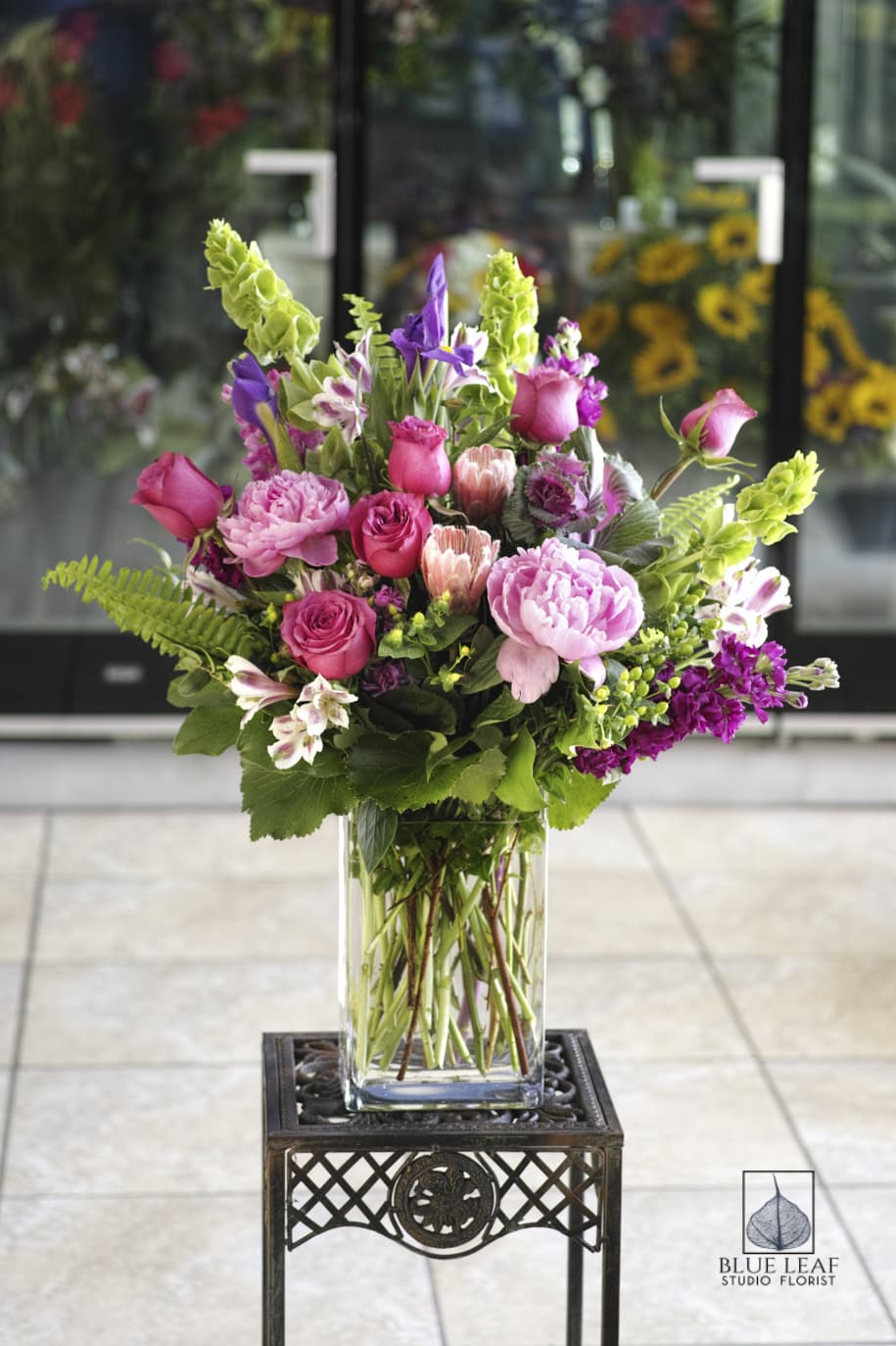 Pink and purple mixed bouquet in a clear glass vase