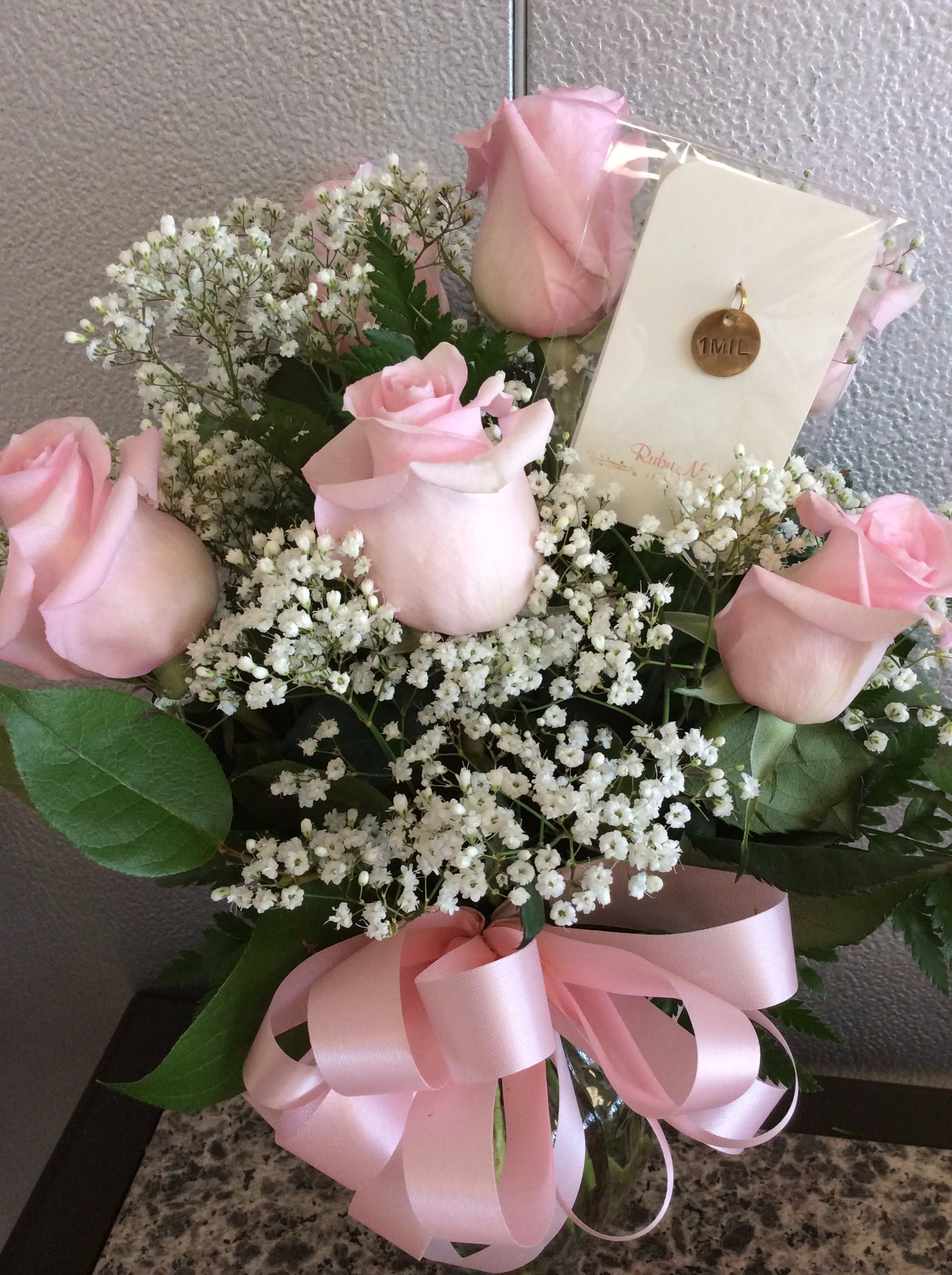 1 Mil Pink - 6 Pink Roses arranged in glass vase w/ greens &amp; filler w/ "1 Mil" RubyMae Charm included. Perfect for that someone who is your "1 in a Million"!!  Approx. Height 18"