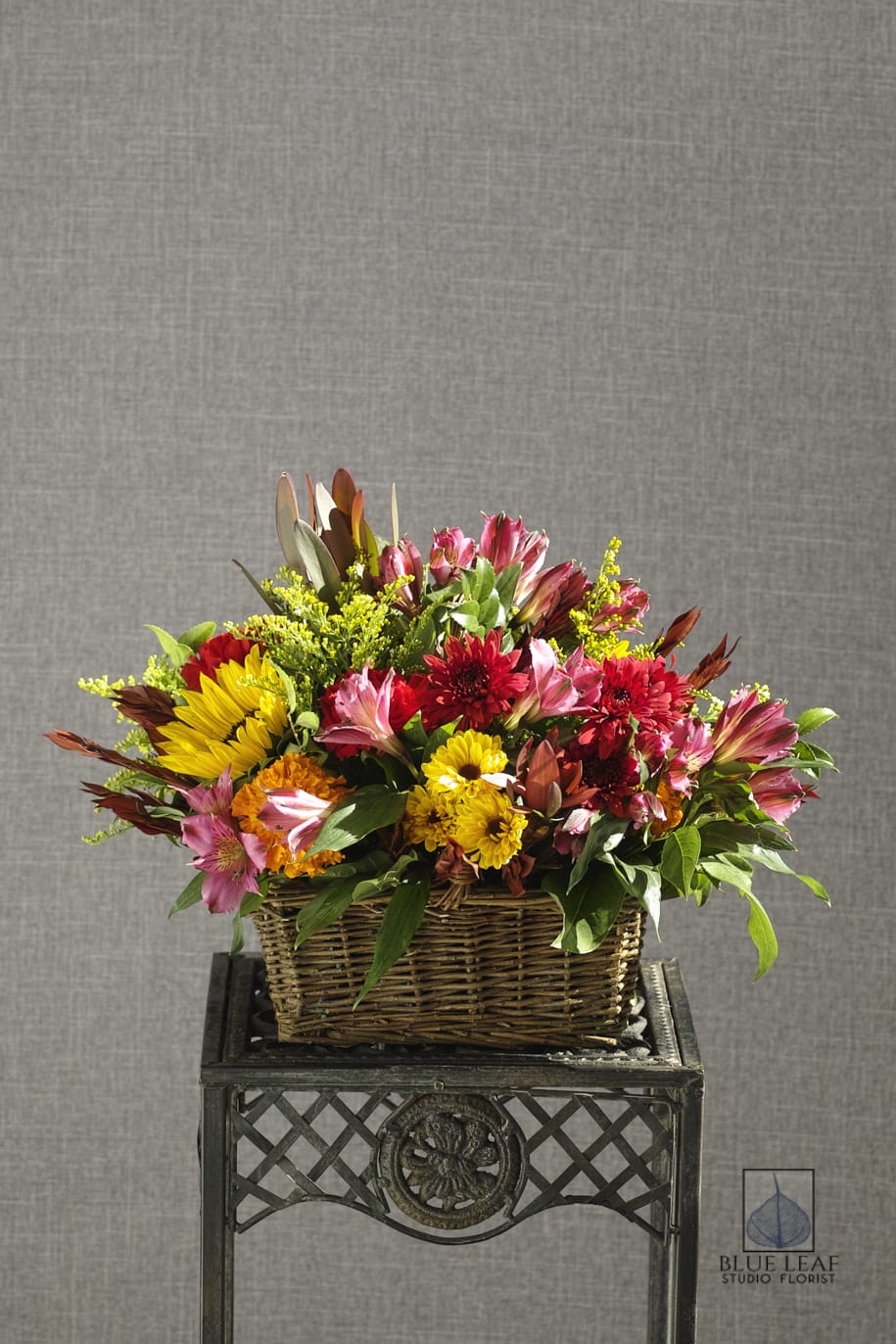 Colorful mixed flower arrangement in a wicker basket
