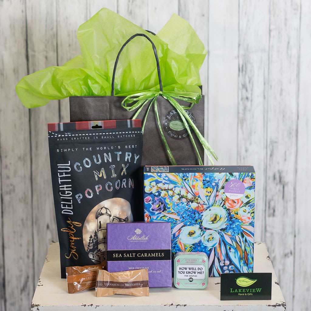 Gift bag with popcorn, candy, puzzle, and small game items