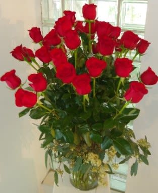 Tall bouquet of red roses in a glass vase