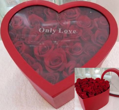 Heart-shaped red box filled with red roses and labeled Only Love