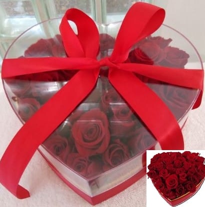 Heart-shaped box of red roses tied with a large red ribbon