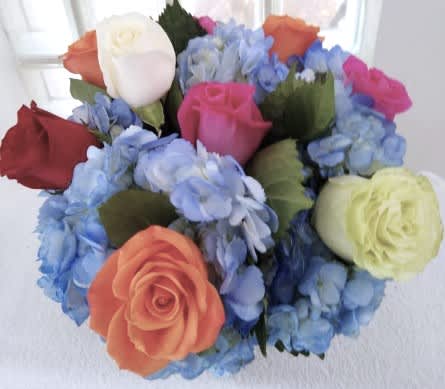 Eyes on You - A cute showstopper. Bright multicolored roses make this darling arrangement pop. Perfect for Best Friends Day, Parents Day, or just because, this arrangement will light up somebody's day.   APPROXIMATE DIMENSIONS 10" W X 10" H